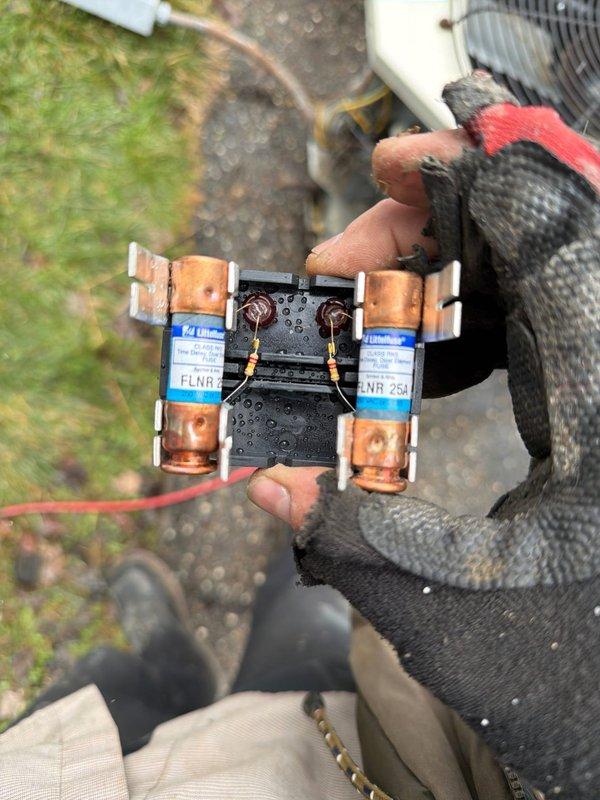 # HVAC Install - Complete System Job Description

Completed full installation of 80% AFUE gas furnace and matching air conditioning system at residential property. Installed new Lennox outdoor condensing unit on level pad against exterior wall with proper clearances maintained for airflow and service access. Unit positioned on black composite equipment pad with appropriate drainage considerations.

Performed complete electrical installation including new disconnect box mounted to exterior siding per code requirements. Installed and tested 25-amp FLNR fuses in outdoor disconnect enclosure to provide proper overcurrent protection for condensing unit. Verified all electrical connections were secure and properly terminated with appropriate wire gauges for equipment specifications.

Completed refrigerant line set installation connecting outdoor condensing unit to indoor evaporator coil. Lines properly insulated and secured along exterior wall routing. System evacuated to proper vacuum level