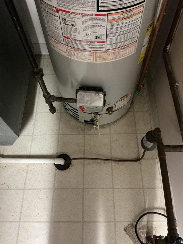 # Service Report: Tanked Water Heater Replacement

Responded to service call for 30-year-old residential water heater that had ceased producing hot water. Upon arrival and inspection, determined that the existing unit had reached end of serviceable life and replacement was the most cost-effective solution rather than repair. 

Completed full water heater replacement including removal of old unit and installation of new gas-fired tanked water heater. Work included proper connection of hot and cold water supply lines using existing copper piping infrastructure, installation of shutoff valves, and connection to existing gas supply line. Verified proper venting through existing stainless steel flue pipe system with secure connections and appropriate clearances. Installed temperature and pressure relief valve with drain line extending to floor level per code requirements. Connected all plumbing fittings and tested for leaks at all connection points.

Fired unit and verified proper ignition,