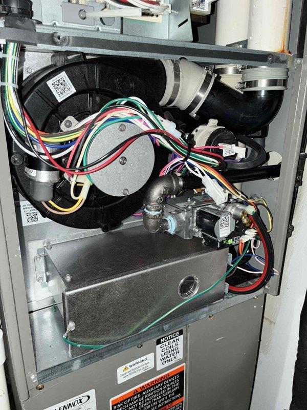Completed annual preventative maintenance on one-year-old Lennox furnace and air conditioning system. Performed comprehensive inspection of blower motor assembly, gas valve components, electrical connections, and combustion chamber; verified all wiring harnesses secure and properly routed; confirmed system controls and safety switches operational. All components found in good working condition with no issues identified.