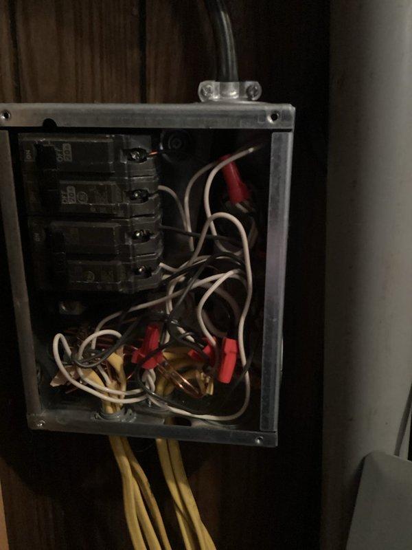 Responded to service call for partial power outage in 1981 double wide mobile home where occupant was relying on extension cords for power to half of the residence. Upon arrival, performed comprehensive inspection of main electrical distribution panel. Found multiple issues including disorganized wiring, improper wire connections with several wire nuts at bottom of panel, and evidence of overloaded circuits. Documented panel conditions with photographs showing aged breakers, bundled conductors entering from top and bottom, and mixed wire routing throughout enclosure. Panel exhibited signs of deterioration consistent with 45-year-old installation. Identified several circuit breakers in various states requiring attention, with colored indicators suggesting previous tripping or failures. Assessed overall electrical system integrity and determined extent of repairs needed to restore full power to affected areas of home. Provided detailed assessment and repair recommendations to restore saf