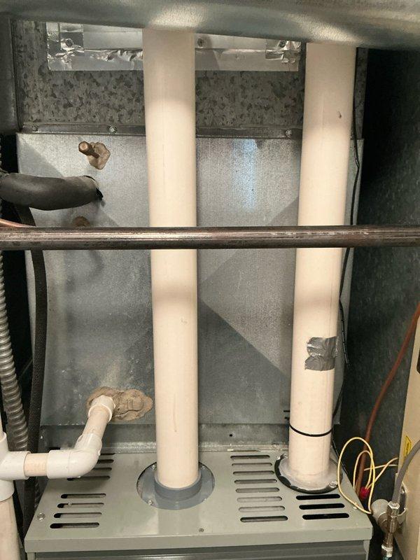 Provided comprehensive estimate for complete HVAC system replacement including furnace, air conditioning unit, whole-home humidifier, and Bradford White tankless water heater for residential property with 19-year-old existing equipment. Documented current system configuration showing existing PVC venting, ductwork connections, and mechanical room layout to ensure accurate equipment sizing and installation planning for the proposed replacement system.