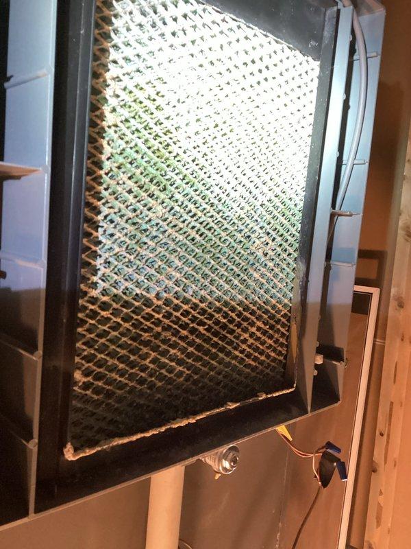 # HVAC Maintenance Visit - Dual System Service

Completed recurring maintenance visit on two HVAC systems with reported humidifier leakage issues. Performed comprehensive inspection of both heating units and identified severely clogged air filter as contributing factor to system inefficiency. The filter exhibited heavy dust and debris accumulation throughout lower two-thirds of mesh material, restricting proper airflow and potentially impacting overall system performance.

Inspected Lennox heating unit and associated components, verifying proper installation and operational status. Examined humidifier connections, drainage lines, and mounting hardware on both systems to identify source of reported leakage. Documented equipment conditions through photographic evidence showing filter contamination levels and overall system configuration. All manufacturer specifications labels and equipment identifiers were verified as present and legible for future service reference.

Addressed humidifie