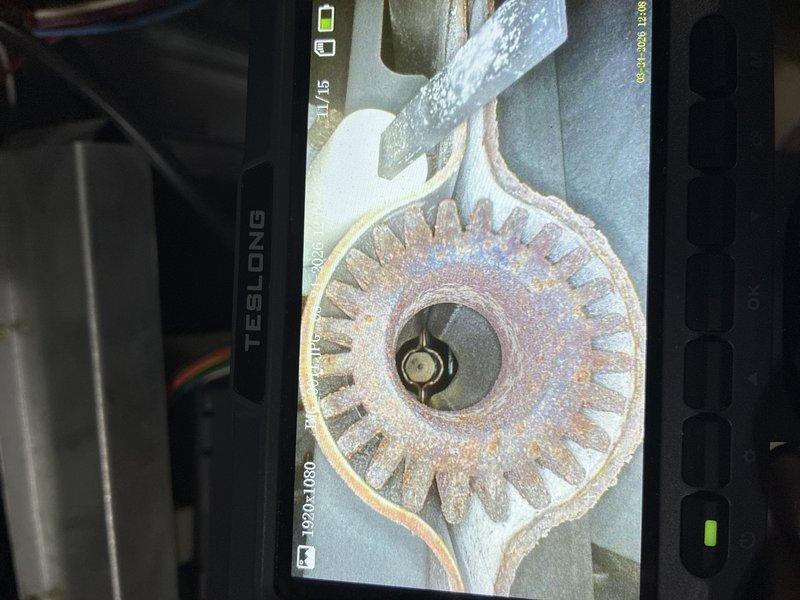 Completed heating system inspection and internal component evaluation using borescope camera equipment. Visual examination revealed significant rust and corrosion on the heat exchanger assembly, particularly affecting the circular burner component and radiating fin structure. The metal surfaces displayed extensive oxidation with reddish-brown discoloration throughout, indicating advanced deterioration that requires immediate attention to ensure safe system operation.