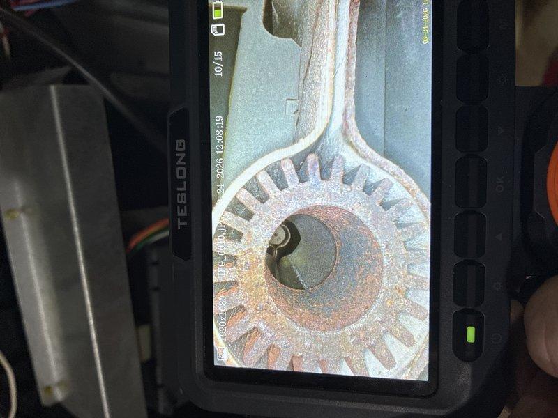 Completed heating system inspection and internal component evaluation using borescope camera equipment. Visual examination revealed significant rust and corrosion on the heat exchanger assembly, particularly affecting the circular burner component and radiating fin structure. The metal surfaces displayed extensive oxidation with reddish-brown discoloration throughout, indicating advanced deterioration that requires immediate attention to ensure safe system operation.