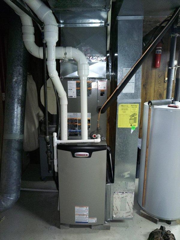 Completed installation of new Lennox air conditioning system with matching evaporator coil in basement mechanical room. Installed new 25-amp FLNR fuses in outdoor disconnect box to provide proper electrical protection for the condensing unit. Verified all ductwork connections to plenum, tested system operation, and confirmed proper refrigerant charge and airflow throughout the system.