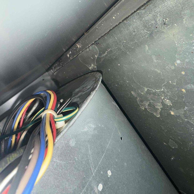 Completed comprehensive tune-up on 5-year-old air conditioning system. Performed combustion analysis on heating components, recording oxygen levels at 7.2%, carbon monoxide at 42 ppm, efficiency at 80.7%, and carbon dioxide at 7.7% using calibrated gas analyzer. Inspected control wiring and electrical connections in air handler compartment, verified all wire terminations secure, and cleaned accumulated dust and debris from equipment surfaces and components to ensure optimal system operation.