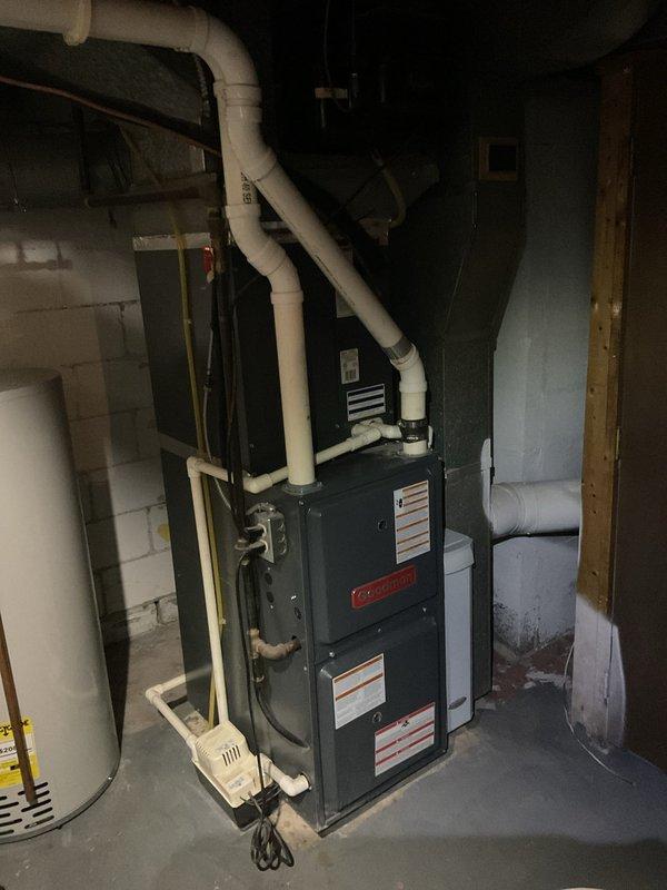 Completed routine MVP heating maintenance visit on Goodman brand furnace system. Performed comprehensive inspection of unit, verified proper operation of all components including blower assembly, heat exchanger, and venting system. Documented equipment condition with photographs showing furnace installation, PVC venting configuration, and associated mechanical components in proper working order.