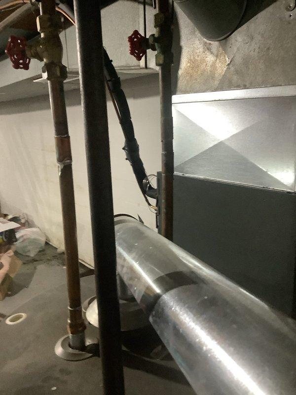 Responded to service call for leaking hot water tank with no hot water availability. Upon inspection, confirmed active leak from existing tanked water heater and complete loss of hot water supply. Evaluated mechanical room configuration, existing plumbing connections including copper supply lines, gas piping with sediment trap, and electrical connections. Provided comprehensive estimate for conventional tanked water heater replacement as well as alternative tankless water heater installation option. Documented existing system layout including shut-off valves, pressure relief components, and venting configuration through photographic records for replacement planning and same-day installation coordination.