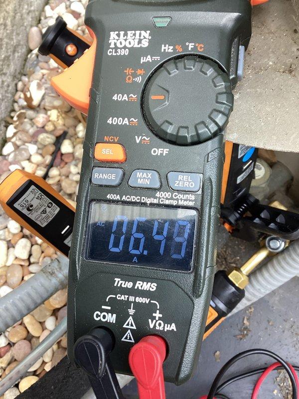 Completed preventive maintenance tune-up on residential air conditioning system. Removed condenser top panel, performed electrical diagnostics with digital clamp meter reading 6.44 amps, and inspected refrigerant lines and internal components. All system parameters tested within normal operating range.