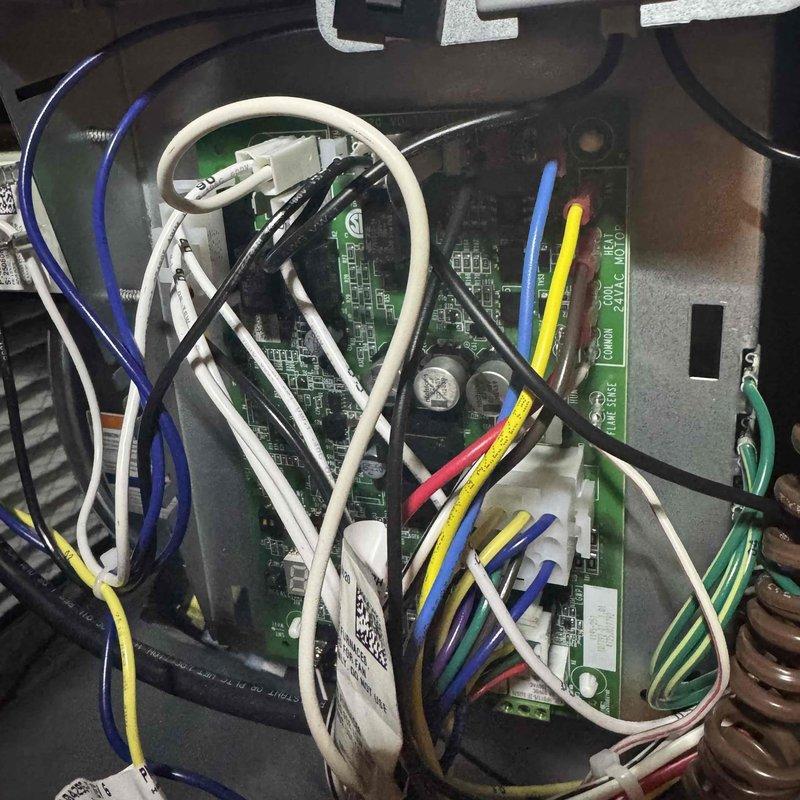 Responded to service call for furnace making unusual noise and hesitating during startup. Upon inspection, performed diagnostic testing on the control board (PCB) that was recently installed. Connected test leads to circuit board terminals to verify proper voltage and component function at the 120-volt hot connections. Inspected all wire connections, terminal blocks, and electronic components for loose connections or signs of failure. System tested and found operating within normal parameters after diagnostic evaluation.