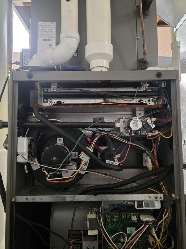 Completed comprehensive maintenance inspection on residential air conditioning system. Removed access panels to evaluate internal components including evaporator coil assembly, blower motor, electrical connections, and control boards. Inspected heat exchanger, copper refrigerant lines, and PVC condensate drain connections for proper operation. Verified all wire terminations, relay assemblies, and circuit board functionality. Noted dust accumulation on internal components and minor debris in base pan. System operational with all mechanical and electrical components functioning within normal parameters.