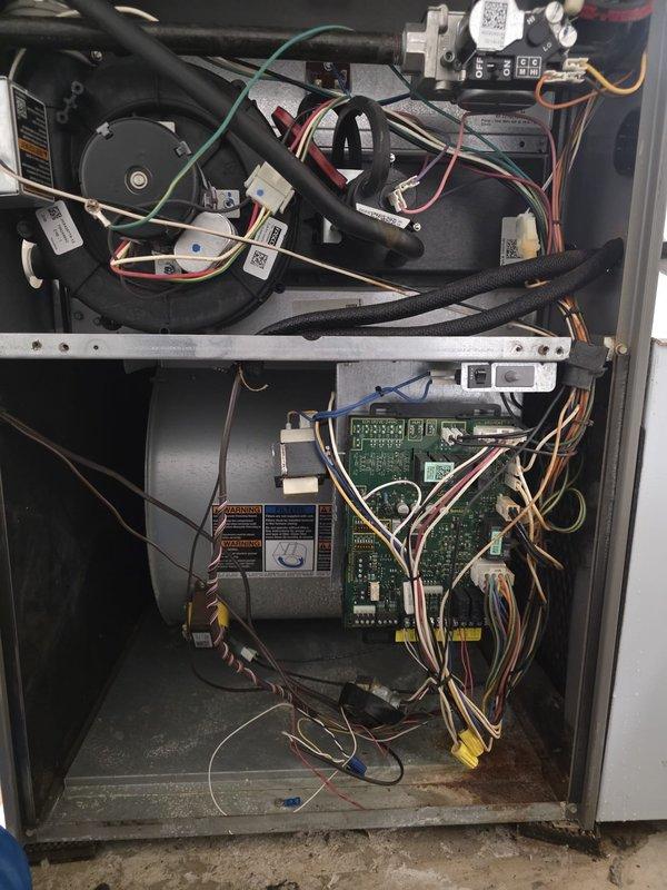 Completed comprehensive maintenance inspection on residential air conditioning system. Removed access panels to evaluate internal components including evaporator coil assembly, blower motor, electrical connections, and control boards. Inspected heat exchanger, copper refrigerant lines, and PVC condensate drain connections for proper operation. Verified all wire terminations, relay assemblies, and circuit board functionality. Noted dust accumulation on internal components and minor debris in base pan. System operational with all mechanical and electrical components functioning within normal parameters.