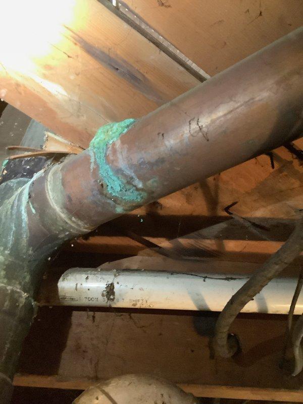 Replaced deteriorated sections of PVC drainage piping in basement, eliminating all rubber connections from stack tie-in point back to kitchen sink riser. Reworked lavatory sink drain line to proper configuration, replacing improper existing connections with code-compliant PVC fittings and pipe. All work completed with new Schedule 40 PVC materials; however, due to pre-existing condition of main stack showing significant corrosion, integrity of adjacent original piping cannot be guaranteed.