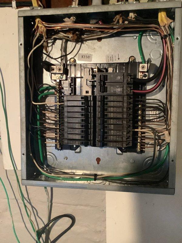 Responded to service call for washer outlet repeatedly tripping the circuit breaker. Inspected electrical panel and identified overloaded circuit causing nuisance tripping. Documented panel configuration and wiring connections with photos showing proper grounding and breaker arrangement. Circuit issue resolved and panel verified operational.