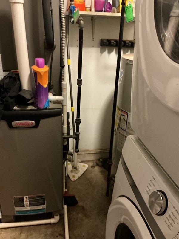# Tanked Water Heater Service Call

Responded to service call for hot water tank issue in residential utility room. Performed diagnostic inspection of water heater unit located in basement mechanical space adjacent to HVAC furnace and laundry appliances. Assessed water heater condition, examined plumbing connections, and verified proper operation of heating elements and temperature controls. Inspected associated piping infrastructure including supply lines and drainage systems visible in utility area. Completed necessary repairs to restore hot water heater to proper working condition. Unit tested and confirmed operational upon completion of service work.