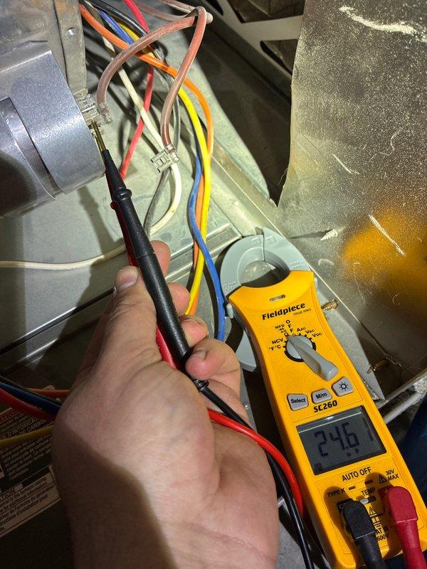 Completed routine preventive maintenance tune-up on 7-year-old residential air conditioning system. Performed comprehensive system inspection including electrical diagnostics with multimeter showing 249V supply, verified proper voltage to all components, and inspected condenser coil which exhibited heavy accumulation of dirt and debris restricting airflow through fins. System operational with no reported issues prior to service visit.