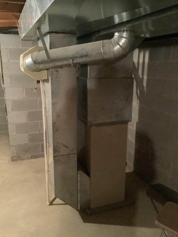 Completed installation of a new 80% efficiency furnace and air conditioning system at residential property. The outdoor AC condenser unit was positioned on the wooden deck with proper gravel base for drainage and vibration dampening, with all electrical connections routed through weatherproof conduit to the existing meter panel. Inside the basement, installed the new furnace unit with appropriate ductwork connections, ensuring proper airflow distribution through the existing duct system and secure mounting on the concrete floor against the foundation wall.