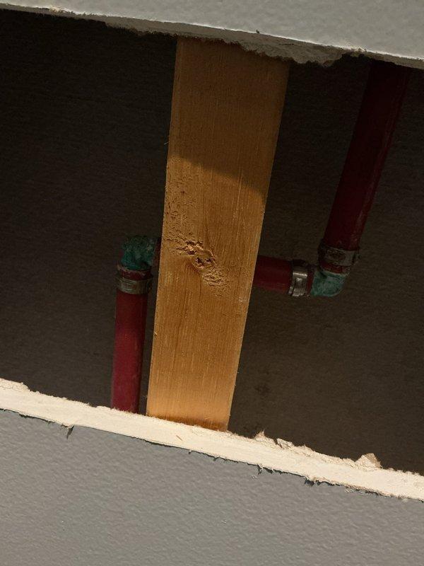 Responded to water leak service call for shower line fitting repair as coordinated with property management. Created access opening in drywall to expose plumbing infrastructure and repaired defective shower supply line fitting. Verified proper installation and secured all plumbing connections before completing work.