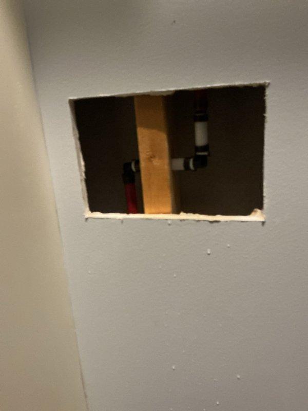 Responded to water leak service call for shower line fitting repair as coordinated with property management. Created access opening in drywall to expose plumbing infrastructure and repaired defective shower supply line fitting. Verified proper installation and secured all plumbing connections before completing work.