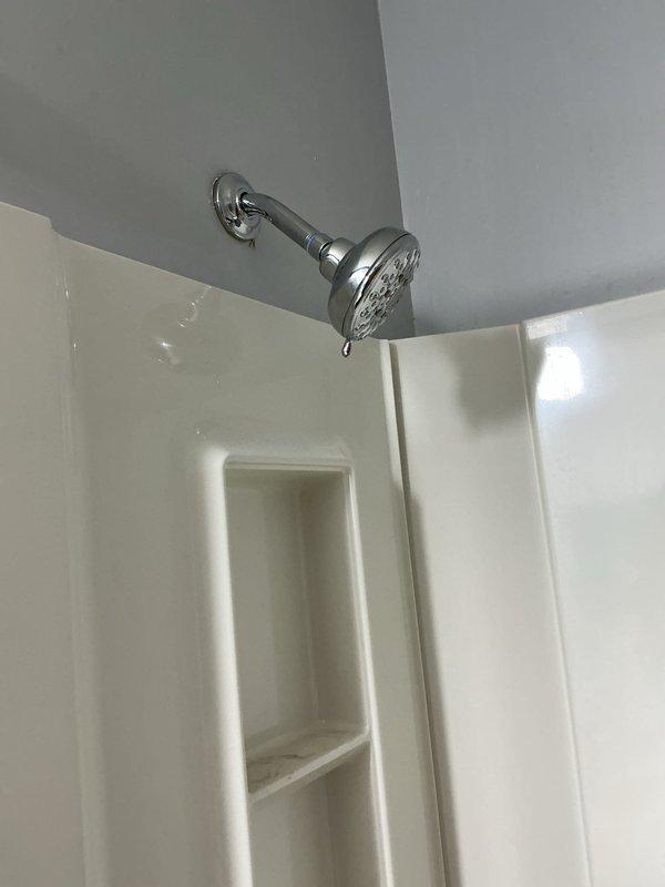 Completed installation of customer-supplied Moen lavatory faucet with new shut-off valves, P-trap, and supply lines. Created wall access opening in hallway behind tub shower area and installed access panel for future maintenance accessibility. In basement drop ceiling, installed two new ball valves on hot and cold water supply lines. Ran new copper risers from basement to bathroom and installed necessary pipe fittings to accommodate new fixture configuration. Installed customer-supplied Moen tub shower valve body and completed trim installation including single-handle control valve, tub spout with diverter, and shower head assembly. All fixtures tested for proper operation and verified no leaks at connections. Chrome finishes properly aligned and secured to wall surfaces.