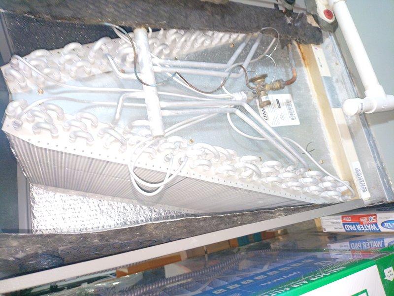 Completed comprehensive tune-up on furnace and air conditioning system. Discovered evaporator coil completely frozen with heavy ice buildup across all surfaces, indicating restricted airflow or refrigerant issue. Inspected blower assembly, mounting brackets, and refrigerant lines; documented conditions and addressed airflow restrictions to restore proper system operation.