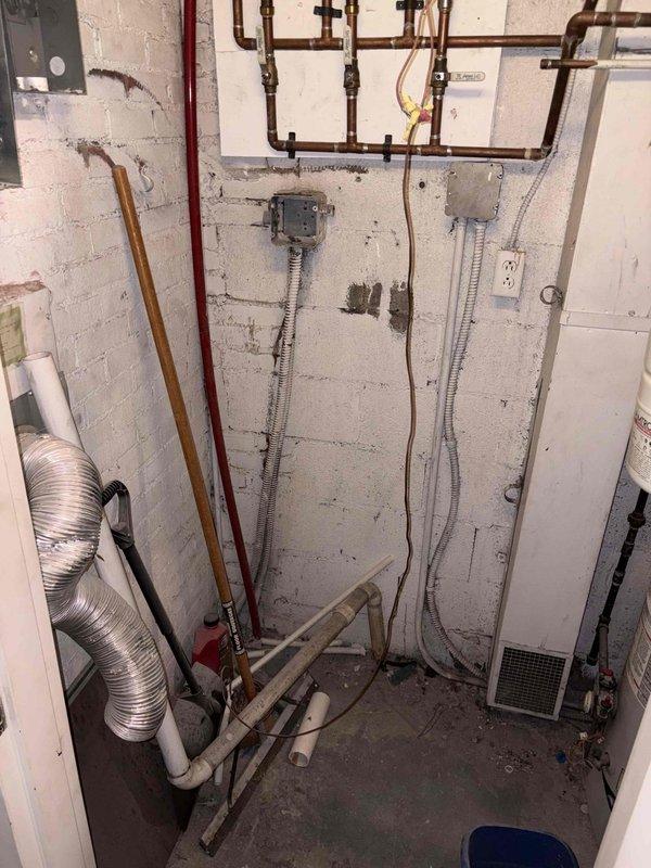 Performed estimate for boiler replacement in vacant condominium unit with existing 60-year-old boiler system. Assessed existing heating distribution system including copper piping, baseboard connections, and utility room configuration for potential boiler upgrade and ducted air conditioning installation with system reconnection.