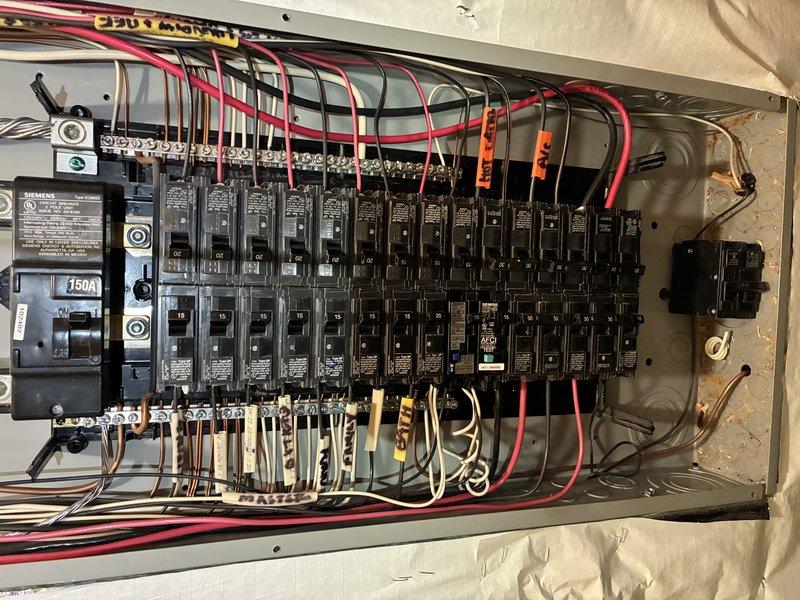 Installed dedicated 240V electrical circuit from main panel to detached garage for EV charger installation. Main 150A panel had no available breaker slots, requiring strategic circuit consolidation to accommodate new 40A double-pole breaker. Ran 8/3 NM-B copper wire approximately 60 feet from panel through attic space to garage location, securing cable per code requirements. Installed NEMA 14-50 receptacle in garage and verified proper voltage, grounding, and circuit functionality. All work completed to current NEC standards for electric vehicle supply equipment circuits.