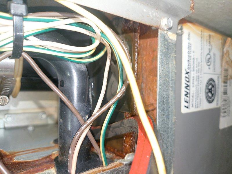 Responded to service call for condensation issue on 5-year-old Lennox furnace. Upon inspection, identified condensate drainage system and verified PVC condensate lines, connections, and trap assembly for proper installation and functionality. Examined internal electrical components, capacitor, and wiring harness to ensure no moisture intrusion or corrosion-related electrical hazards. Documented existing surface rust on internal metal components consistent with normal condensate exposure over time. System operational at time of inspection.
