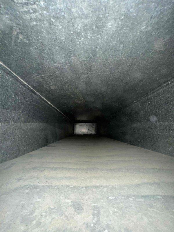Completed comprehensive duct cleaning service for residential HVAC system consisting of 17 vents. System inspection revealed significant accumulation of dust, debris, and particulate matter throughout the ductwork, with heavy buildup on interior surfaces and floors of air channels. Performed thorough cleaning of all ventilation components, removing years of settled contaminants from metal duct surfaces and eliminating the substantial layer of dust and debris that had collected over time, restoring proper airflow and improving indoor air quality.