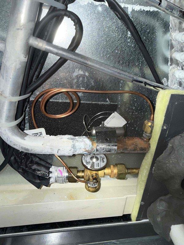 Installed surge protector from truck stock to protect HVAC system from electrical surges and power fluctuations. System showed evidence of frost buildup on evaporator coil and refrigerant lines, indicating potential airflow restriction or refrigerant charge issues that were addressed during service call.
