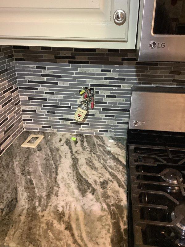 Responded to service call for refrigerator circuit breaker repeatedly tripping and reported power surges. Inspected kitchen electrical system including GFCI outlet on backsplash and appliance circuits serving LG appliances. Tested circuit integrity, verified proper grounding, and assessed breaker condition to identify source of overcurrent condition and power quality issues affecting refrigeration circuit.