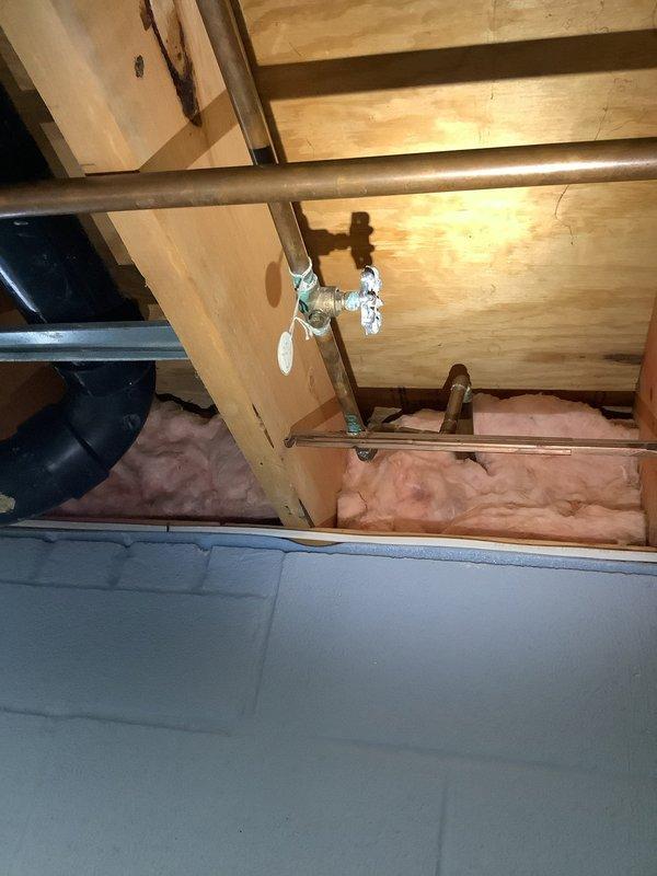 Responded to a leaking interior shut-off valve serving an outdoor spigot line. Located the valve in the crawl space among exposed copper piping and structural framing. Replaced the faulty shut-off valve with a new brass ball valve, ensuring proper connection to the existing copper supply line. Tested the system for leaks and verified proper operation of the valve mechanism. The outdoor spigot line is now isolated and functioning without leakage.