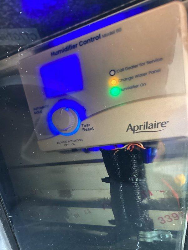 Completed comprehensive furnace maintenance including full system inspection and testing. Verified Aprilaire Model 60 humidifier operation with control panel showing normal status indicators; green "Humidifier On" light confirmed active operation while amber "Change Water Panel" light indicated scheduled maintenance due. Inspected all refrigerant lines, connections, and insulation throughout the system with no leaks or damage observed. All mechanical components, including compressor housing and brass fittings, found in proper working condition with system operating within manufacturer specifications.