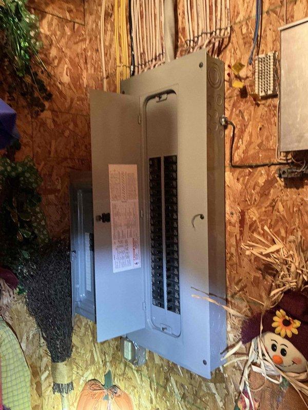 Conducted on-site electrical assessment for generator installation at residential property. Documented existing electrical panel configuration and available space for generator integration. Property features accessible driveway with adequate turning radius for equipment delivery and installation. Photographed main service panel and subpanel locations to determine optimal transfer switch placement and circuit integration points for proposed backup power system.