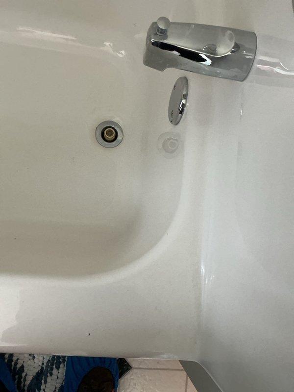 Responded to service call for sink faucet replacement at a 32-year-old residential property. Upon arrival, assessed the existing plumbing fixtures and determined the bathtub spout required replacement rather than a sink faucet. Removed the old chrome bathtub spout and diverter assembly, inspected the copper stub-out for proper thread condition and corrosion, and installed a new chrome-finished tub spout with integrated diverter mechanism. Verified proper water flow and diverter operation, checked for leaks at the connection point, and confirmed all components were securely mounted. Also noted evidence of previous water intrusion visible on the ceiling surface near the bathroom area, which may require future monitoring. All plumbing fixtures tested and left in proper working condition.