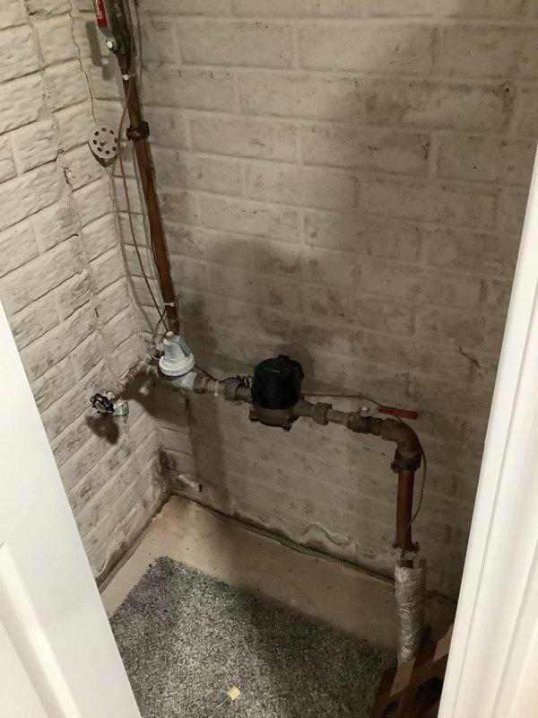 Responded to multiple drain blockages throughout a 20-year-old residence affecting bathroom sink, toilet, dishwasher, and shower. Upon arrival, performed systematic assessment of all affected fixtures to determine extent and location of clogs. 

Inspected main water supply lines and plumbing infrastructure in utility closet, noting copper piping with existing shut-off valves and flow control devices. Verified water pressure and supply functionality to rule out main line issues. Assessed condition of visible plumbing connections and support brackets.

Cleared bathroom sink drain using appropriate augering techniques to remove accumulated debris and buildup. Addressed toilet blockage through mechanical snaking, successfully restoring proper flush and drainage function. Cleared shower drain obstruction, removing hair and soap residue buildup that had accumulated over time.

Investigated dishwasher drainage issue, checking air gap, drain hose routing, and connection to garbage disposal or 