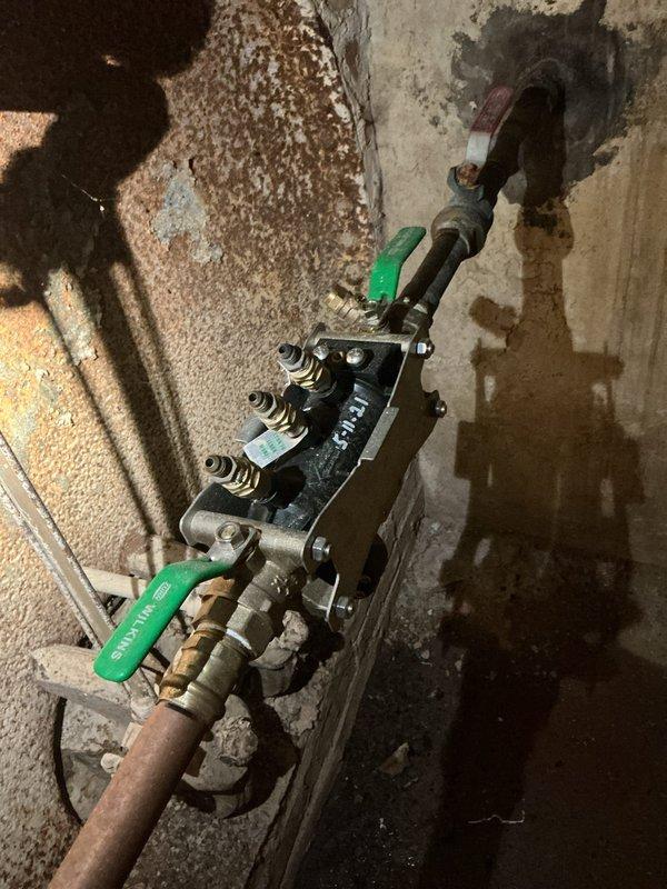 Completed annual backflow preventer inspection and testing on a 1" Watts 375XL RP assembly (serial #AE 2780). Performed diagnostic testing using calibrated test gauges (Watts TK9A, serials 511962 and 0115394, range 0-15 PSID) on the dual check valves and relief valve. Both check valves tested at 10.5 PSI differential and relief valve at 2.4 PSI, with all components passing inspection criteria and meeting regulatory compliance standards for backflow prevention.