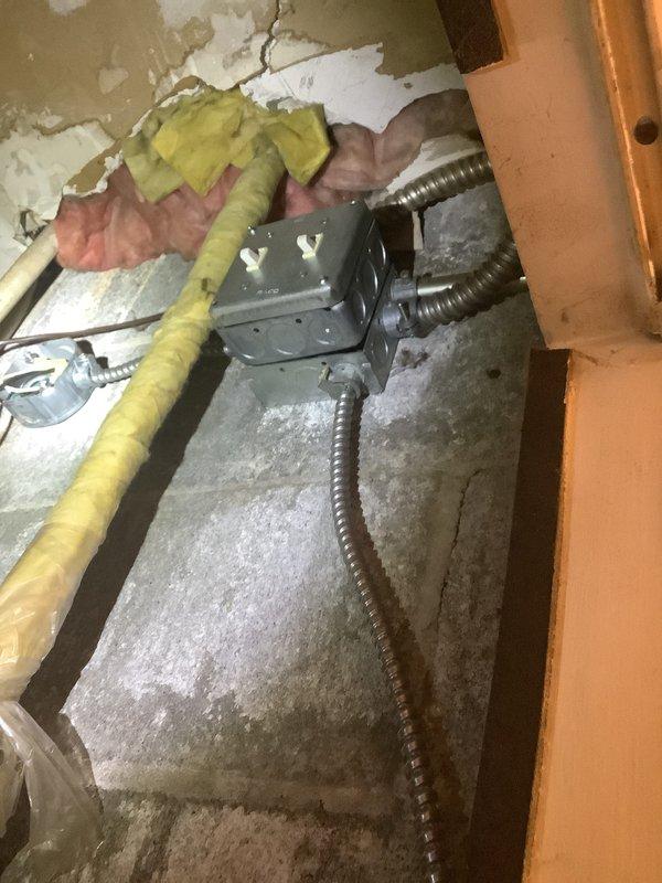 Performed comprehensive assessment of existing package unit system for replacement estimate. Inspected attic-mounted electrical junction box with metal conduit connections, noting accumulated debris and exposed infrastructure. Evaluated basement mechanical room plumbing components including insulated piping with gate valves showing age-related wear and discoloration. Documented all equipment conditions and system configurations through photographic documentation to provide accurate replacement specifications and scope of work for new package unit installation.