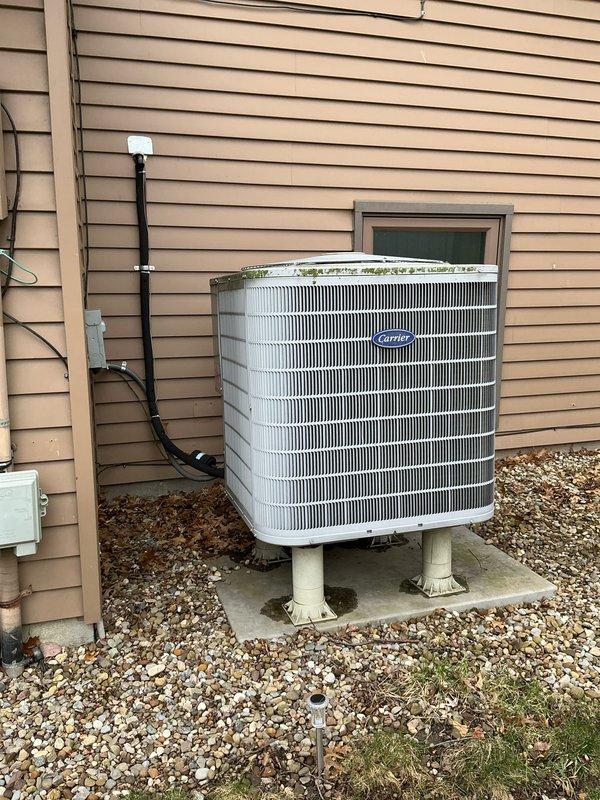 Conducted comprehensive HVAC system evaluation for complete equipment replacement at residential property. Assessed existing Carrier brand condensing unit positioned on exterior concrete pad with proper electrical disconnect and refrigerant line routing, as well as indoor air handling equipment in basement utility area. Documented current system configuration, equipment specifications, and installation conditions through detailed photography to provide accurate replacement estimate for new heating and cooling system.