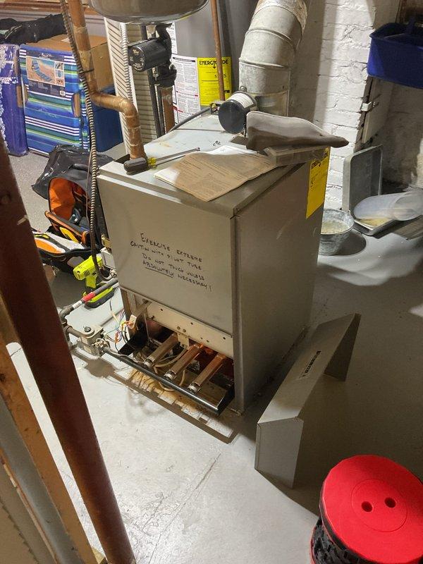 Responded to service call for 13-year-old residential gas boiler displaying error code 57. Upon arrival, performed diagnostic assessment of the heating system and identified the fault condition. Inspected boiler components, electrical connections, and control panel to determine root cause of error code. Documented equipment condition with photographs showing boiler unit, pressure gauge readings, copper piping connections, electrical panel, and associated mechanical components. Communicated diagnostic findings to appropriate contacts for determination of repair or replacement recommendations.