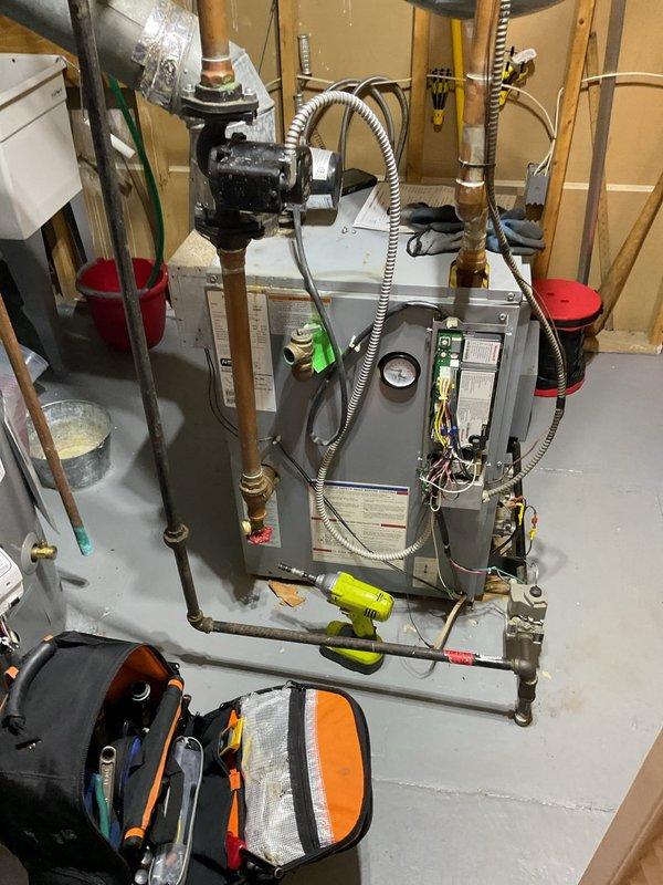 Responded to service call for 13-year-old residential gas boiler displaying error code 57. Upon arrival, performed diagnostic assessment of the heating system and identified the fault condition. Inspected boiler components, electrical connections, and control panel to determine root cause of error code. Documented equipment condition with photographs showing boiler unit, pressure gauge readings, copper piping connections, electrical panel, and associated mechanical components. Communicated diagnostic findings to appropriate contacts for determination of repair or replacement recommendations.