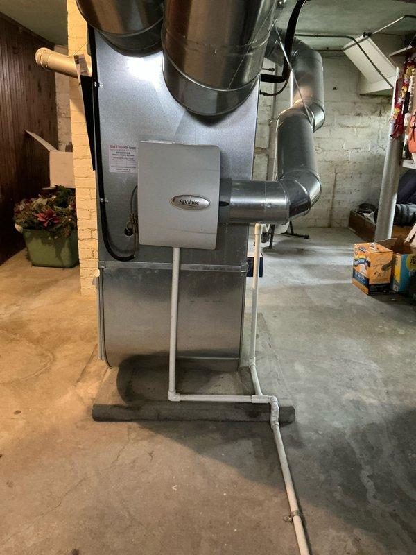 Provided estimate for complete furnace and air conditioning system replacement after identifying over 800 small cracks in the existing heat exchanger, which poses a safety hazard and requires immediate replacement. Documented current basement HVAC installation including existing gray furnace unit mounted on metal stand with associated ductwork and cream-colored AC unit, and presented financing options with promotional interest terms for the recommended system upgrade.