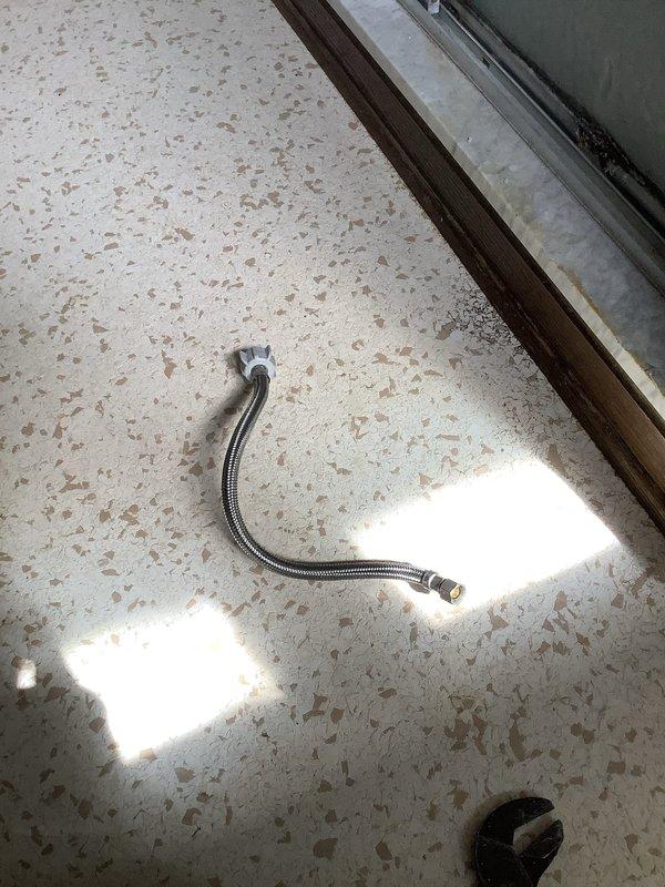 Responded to callback for leaking toilet following previous repair work. Upon arrival, inspected toilet installation and identified failed water supply line connection. Removed defective braided stainless steel supply line and replaced with new flexible connector, ensuring proper thread seal and connection integrity at both shut-off valve and toilet tank inlet. Tested system under full water pressure and confirmed leak was eliminated with no additional drips or seepage detected.