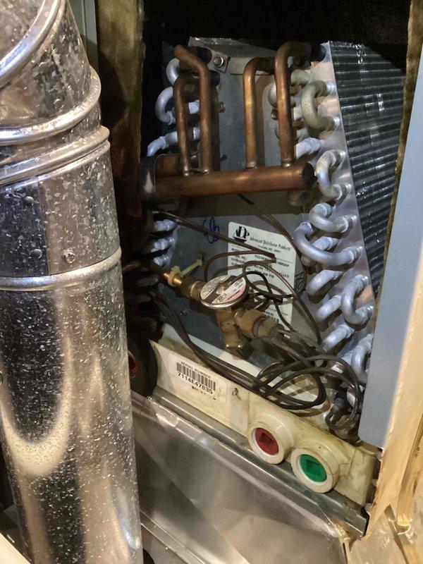 Responded to no-power complaint on 12-year-old air conditioning system. Upon arrival, confirmed complete loss of electrical power to outdoor condensing unit. Performed diagnostic evaluation and determined issue originated at main electrical panel rather than equipment failure. Advised customer that licensed electrician needed to inspect and repair breaker circuit, as problem was beyond scope of HVAC service. Documented system condition with photos showing indoor air handler, refrigerant lines with insulation, condensate management components, and auxiliary equipment in utility space.