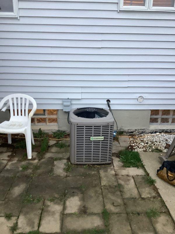 Completed installation of a 90% efficiency furnace and air conditioning system at residential property. New Pulse-branded furnace unit was installed in the basement mechanical room with proper venting using white PVC piping, and outdoor AC condenser unit with beige cabinet and horizontal louvers was positioned on concrete paver patio against exterior of home with appropriate electrical connections and clearances maintained.