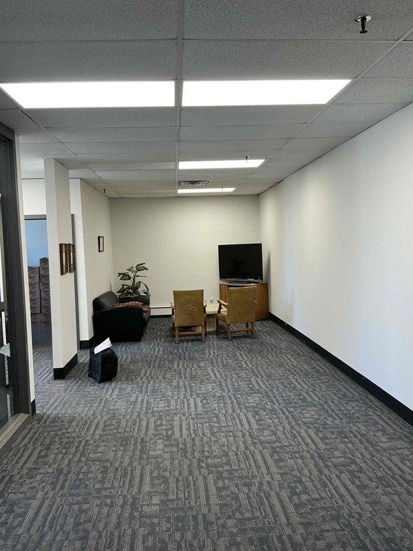 Conducted on-site assessment for mini split installation in office building waiting room and lobby area. Evaluated existing electrical infrastructure including main breaker panel in utility area to determine capacity for new HVAC system. Documented space layout, ceiling configuration with acoustic tiles and recessed lighting, and photographed electrical service panel to verify available circuits and amperage for equipment installation.