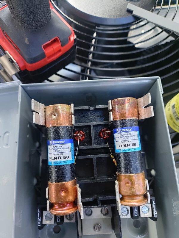 Completed full HVAC system installation including 80% efficiency furnace and air conditioning unit. Installed new condensing unit with proper refrigerant charging, verified system pressures at 257 PSI using calibrated vacuum gauge, and replaced electrical disconnect with new Littelfuse FLNR 50 class RK5 time delay fuses rated at 600 volts for proper overcurrent protection. System tested and operational.