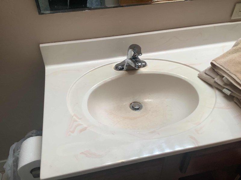 Replaced existing lavatory faucet with new Moen Chateau chrome trim faucet in hall bathroom. Modified galvanized drain nipple in cabinet and installed mission band to properly adapt to new trap assembly. Replaced corroded brass nipples and installed new FIP angle stops on both hot and cold water supply lines, as the cold side was previously missing an angle stop and the hot side stop showed severe corrosion. All connections tested and verified leak-free upon completion.