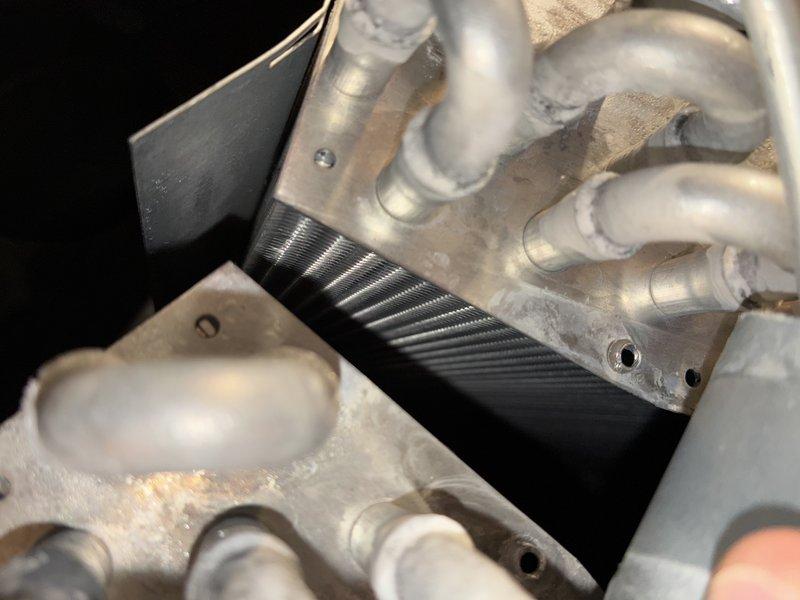 Completed routine BS-MVP cooling maintenance visit on residential HVAC system. Performed comprehensive inspection of evaporator coil assembly and condenser unit, documenting component condition through photographic records. Evaporator coil showed normal operational wear with intact refrigerant line connections and proper brazed joints. Condenser unit exterior exhibited typical outdoor exposure patterns with coil fins and frame in serviceable condition. All major components including heat exchanger surfaces, refrigerant lines, and mounting hardware were verified as functional with no immediate service needs identified.