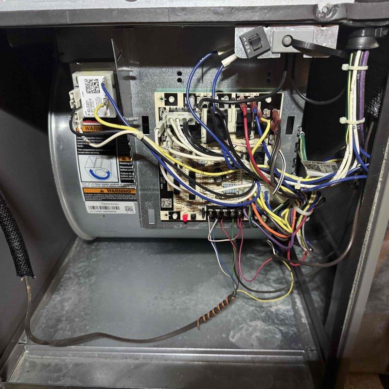 Performed preventive maintenance and tune-up service on two residential central air conditioning systems, both approximately 3-4 years old and operating normally at time of service. Completed comprehensive inspection of both units including visual examination of electrical components, control boards, wiring connections, and blower motor assemblies. Verified proper operation of all system controls and electrical connections, documented equipment condition with photographs showing clean wiring configurations and properly functioning circuit boards. Both systems found to be in good working order with no immediate repairs required.